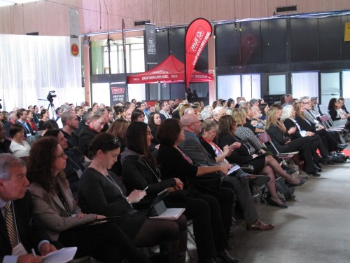 The crowd of cheese industry professionals watches as category champions are announced